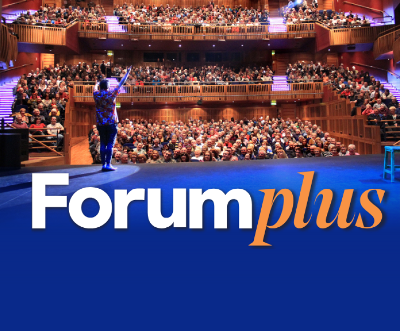 Promotional image for Forum Plus, featuring a speaker on stage addressing a full audience in the Millennium Forum auditorium. The lower half of the image shows the Forum Plus logo in white and orange text against a solid blue background.