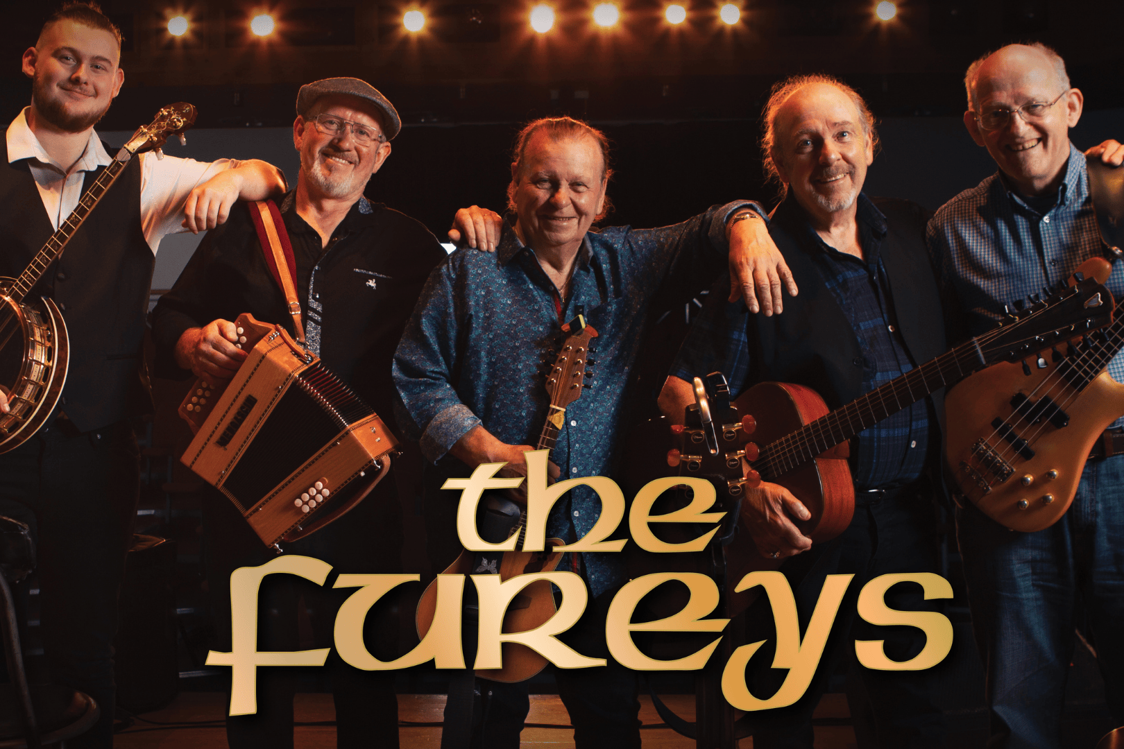 Promotional image for Irish folk band The Fureys. The band members stand side by side on a warmly lit stage, smiling and holding their instruments, including a banjo, accordion, guitar, and bass. The background features soft string lights, creating a welcoming and nostalgic atmosphere. The band’s name, The Fureys, is prominently displayed in bold golden lettering at the bottom centre of the image.
